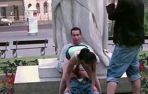 Cute teen girl fucked by 2 guys in PUBLIC in center of the city by famous statue